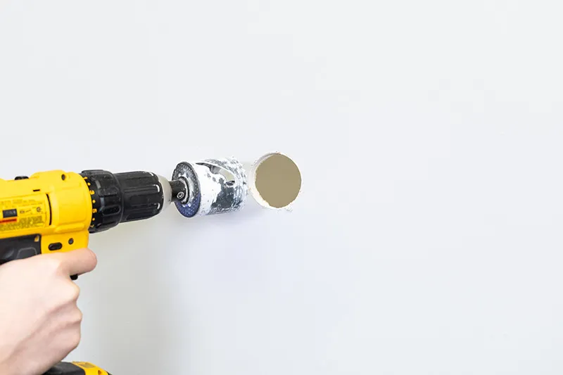 Drilling a hole in drywall with a hole saw